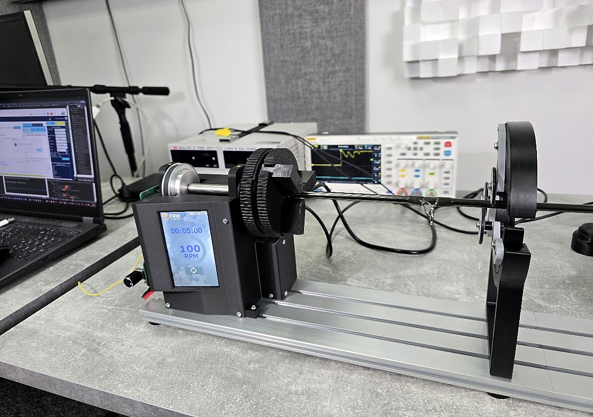 FRW4 prototype with housing, a rod in the chuck and a rod support, test equipment behind